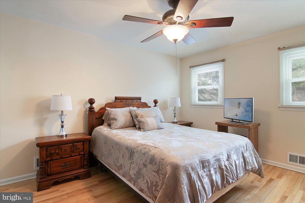 10 Elizabeth Court Edison, NJ 08817 - Photo 14 of 38 a bedroom with a bed and a chandelier