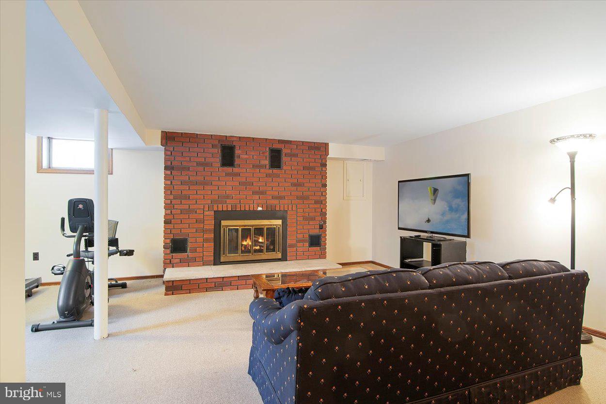 10 Elizabeth Court Edison, NJ 08817 - Photo 22 of 38 a living room with furniture a fireplace and a flat screen tv