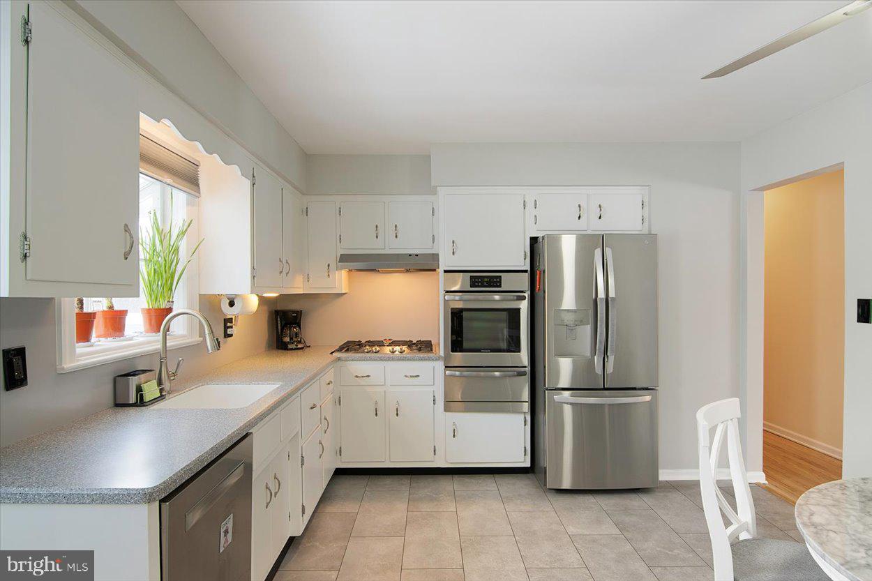 10 Elizabeth Court Edison, NJ 08817 - Photo 9 of 38 a kitchen with white cabinets and stainless steel appliances