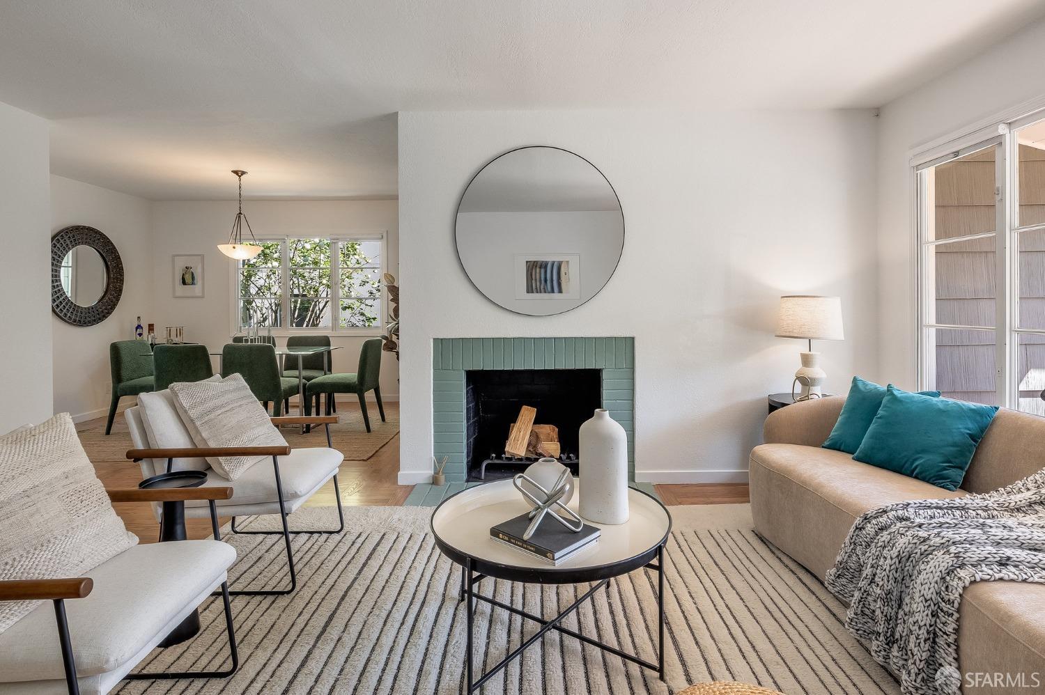 771 Creston Road Berkeley, CA 94708 - Photo 11 of 45 a living room with furniture a fireplace and a large window