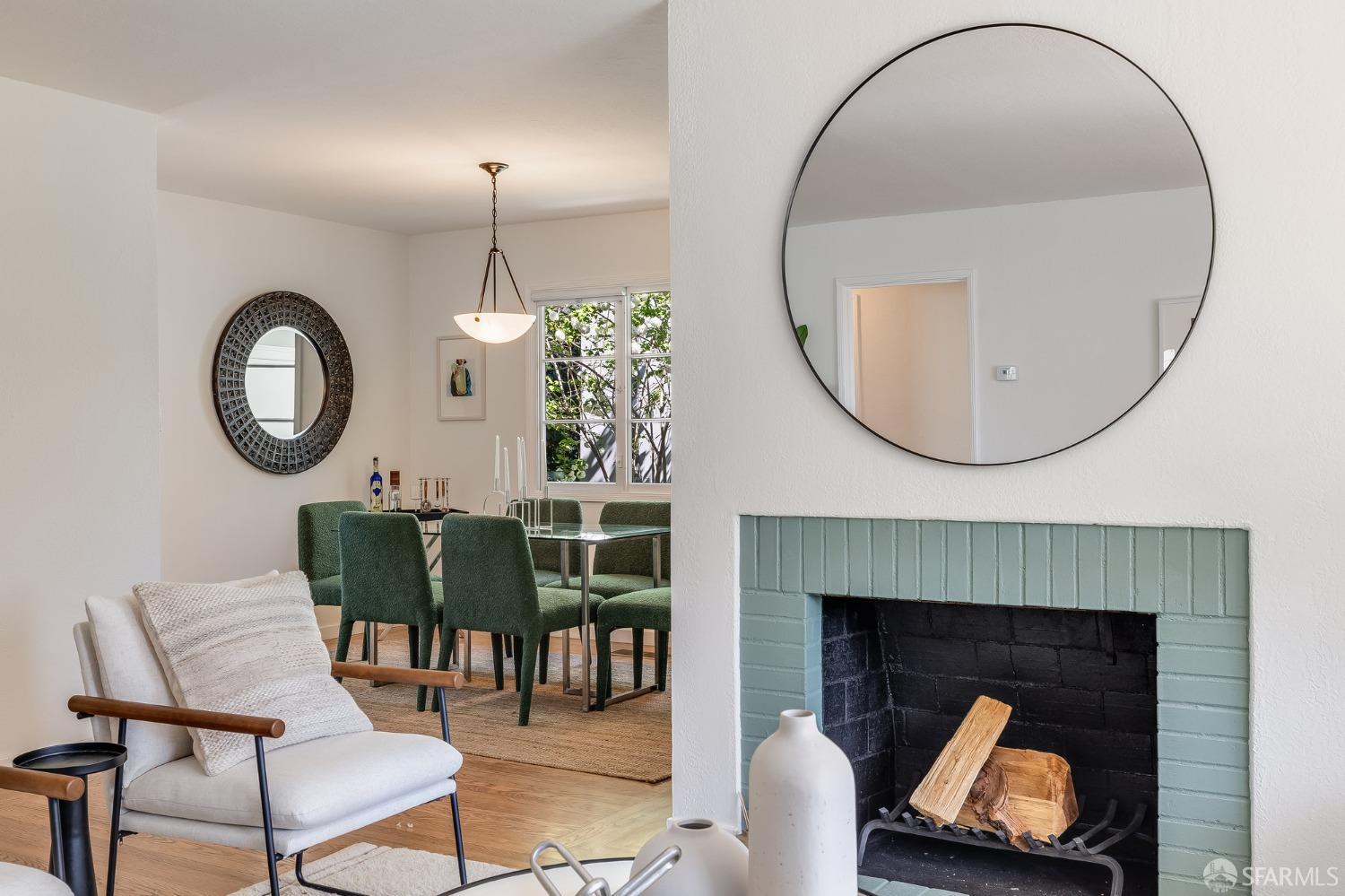 771 Creston Road Berkeley, CA 94708 - Photo 13 of 45 a living room with furniture a mirror and a fireplace