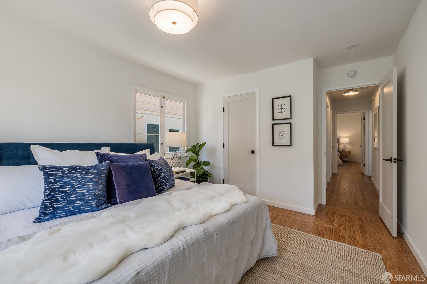 771 Creston Road Berkeley, CA 94708 - Photo 26 of 45 a spacious bedroom with a bed and wooden floor