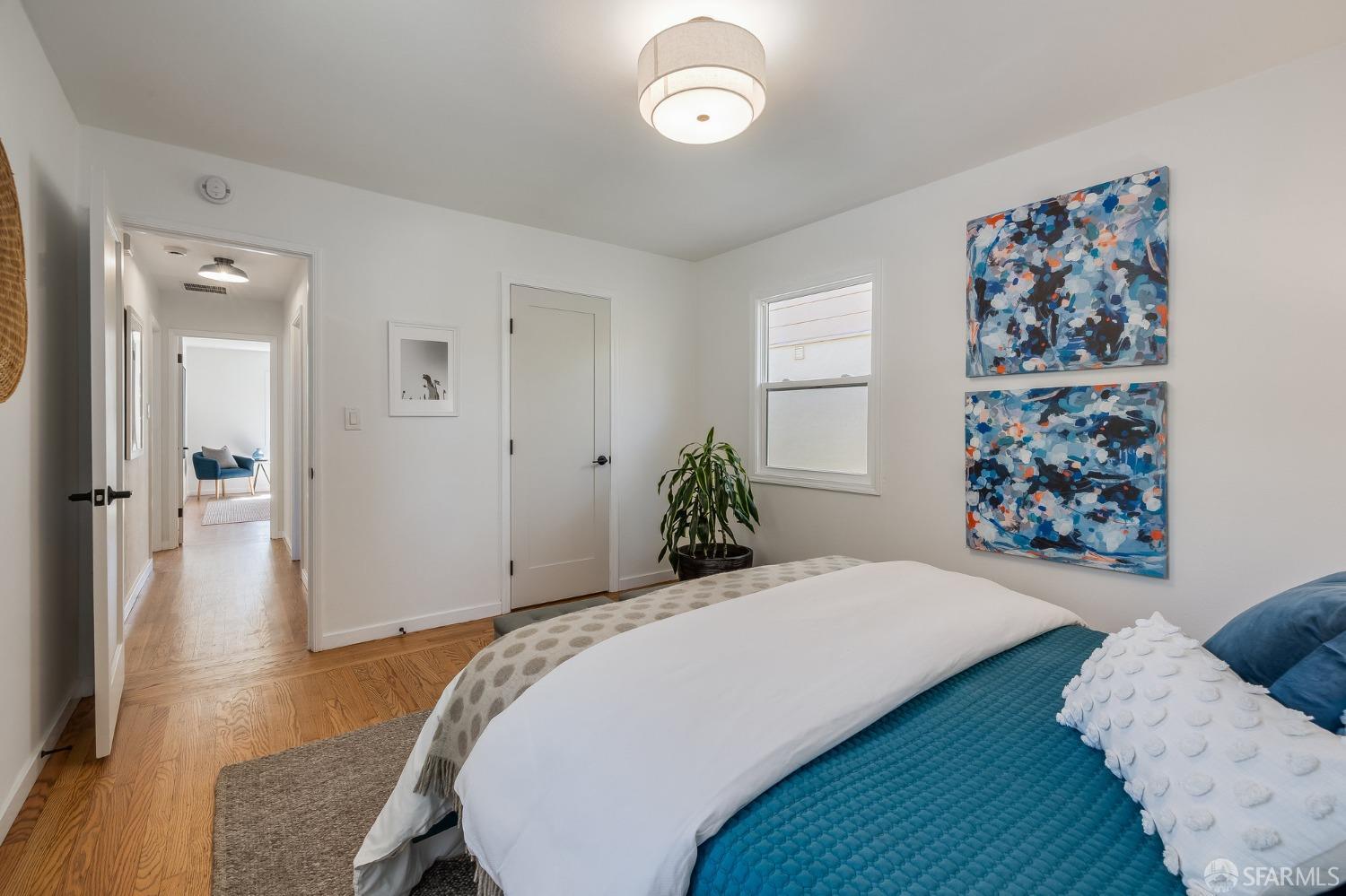 771 Creston Road Berkeley, CA 94708 - Photo 28 of 45 a bedroom with a large bed and a chandelier