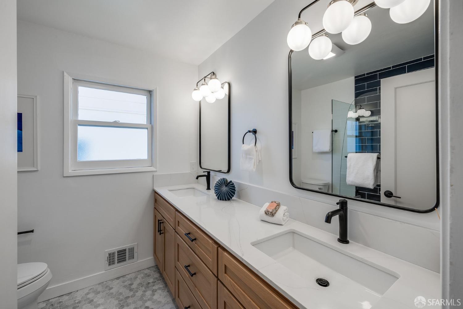 771 Creston Road Berkeley, CA 94708 - Photo 31 of 45 a bathroom with a double vanity sink and a mirror