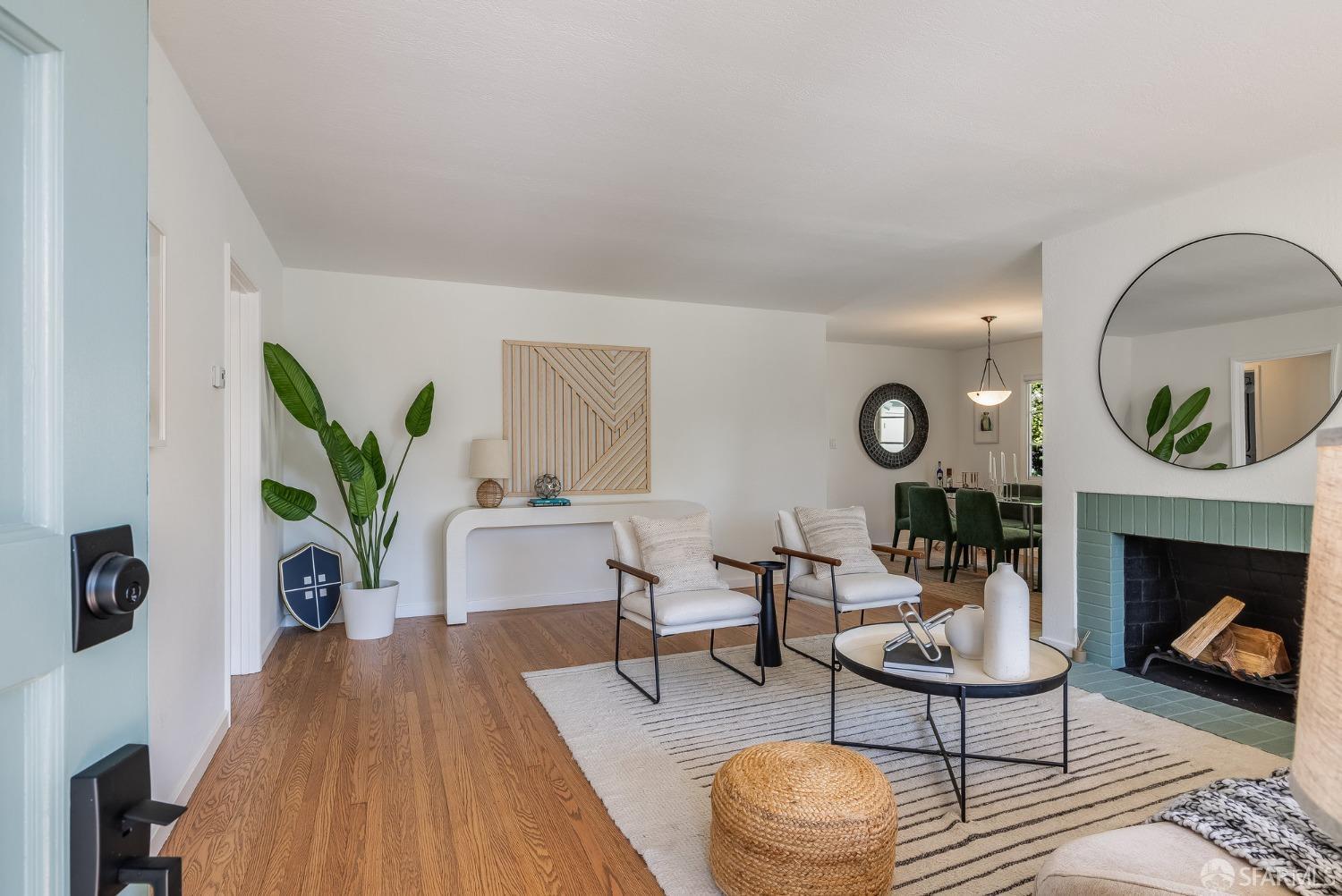 771 Creston Road Berkeley, CA 94708 - Photo 9 of 45 a living room with furniture a fireplace a rug and a potted plant