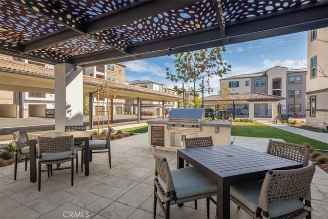 a view of a patio with dining table and chairs with wooden floor