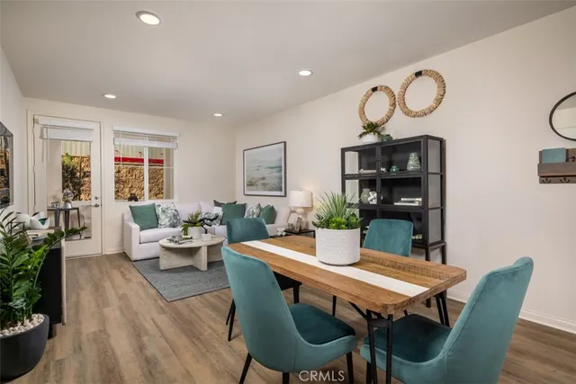 a kitchen with a dining table chairs refrigerator and cabinets