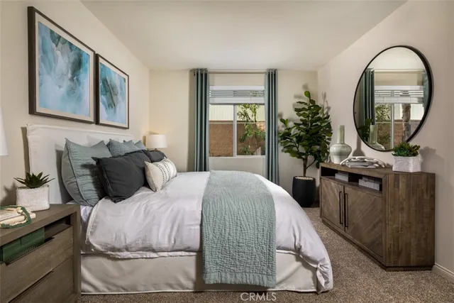 a bedroom with a bed and a potted plant