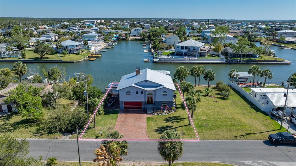 an aerial view of a house with a lake view