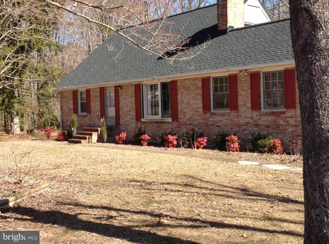 8445 Pine Tree Lane King George, VA 22485 - Photo 1 of 5 a view of a house with snow on the road