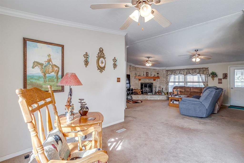 6724 Midway Road Springtown, TX 76082 - Photo 11 of 39 a living room with furniture and a chandelier