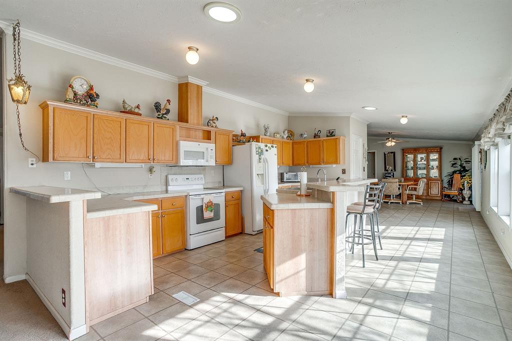 6724 Midway Road Springtown, TX 76082 - Photo 12 of 39 a kitchen with a sink a counter top space stainless steel appliances and cabinets