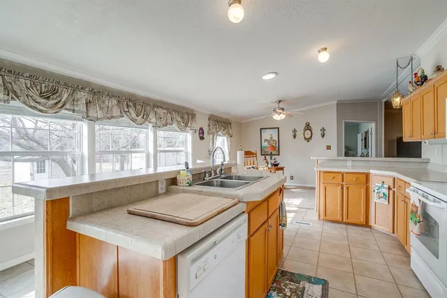 a kitchen with stainless steel appliances granite countertop a sink and a stove