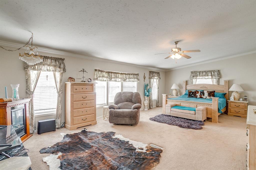 6724 Midway Road Springtown, TX 76082 - Photo 20 of 39 a bedroom with a bed and furniture