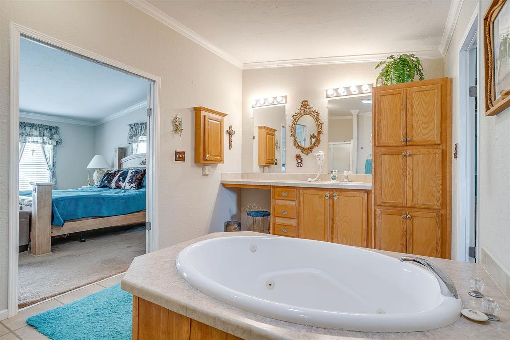 6724 Midway Road Springtown, TX 76082 - Photo 22 of 39 a bathroom with a tub sink and mirror
