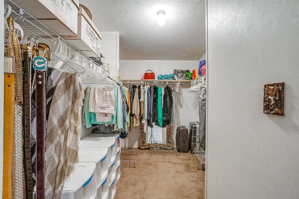 6724 Midway Road Springtown, TX 76082 - Photo 25 of 39 a view of walk in closet with clothes