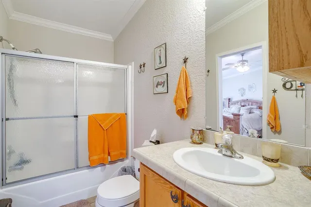 a bathroom with a sink toilet and mirror