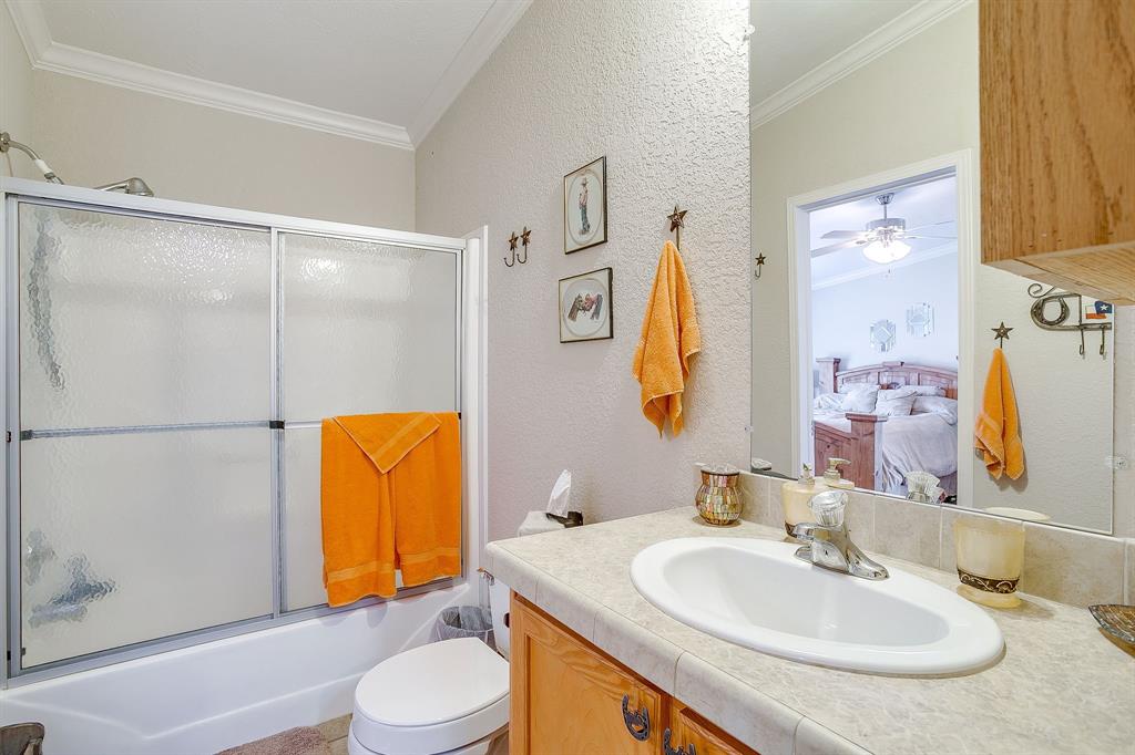 6724 Midway Road Springtown, TX 76082 - Photo 28 of 39 a bathroom with a sink toilet and mirror