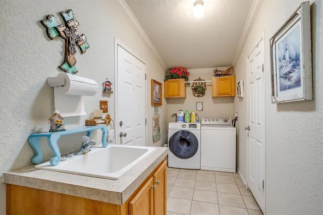 a bathroom with a sink a washer and dryer