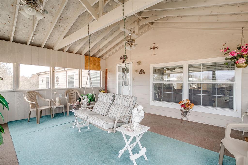 6724 Midway Road Springtown, TX 76082 - Photo 30 of 39 a living room with patio furniture and a chandelier