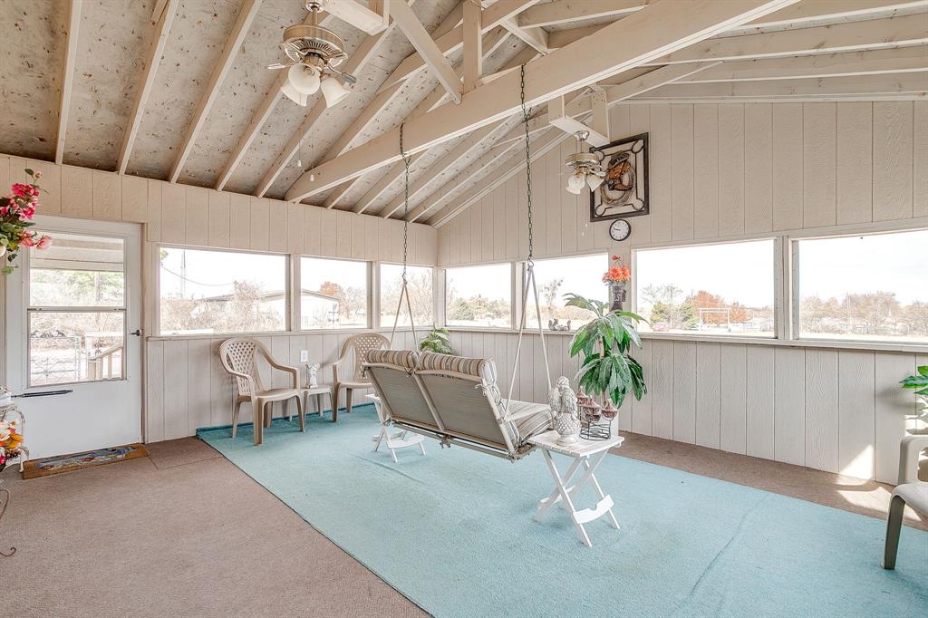 6724 Midway Road Springtown, TX 76082 - Photo 31 of 39 a living room with patio furniture and a floor to ceiling window