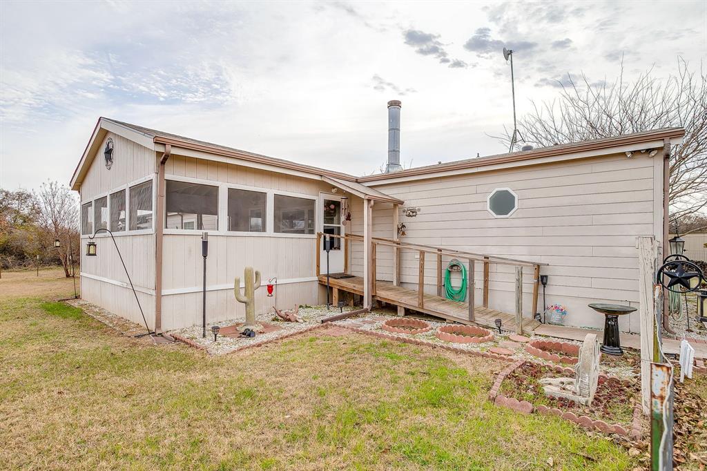 6724 Midway Road Springtown, TX 76082 - Photo 5 of 39 a view of a house with a yard