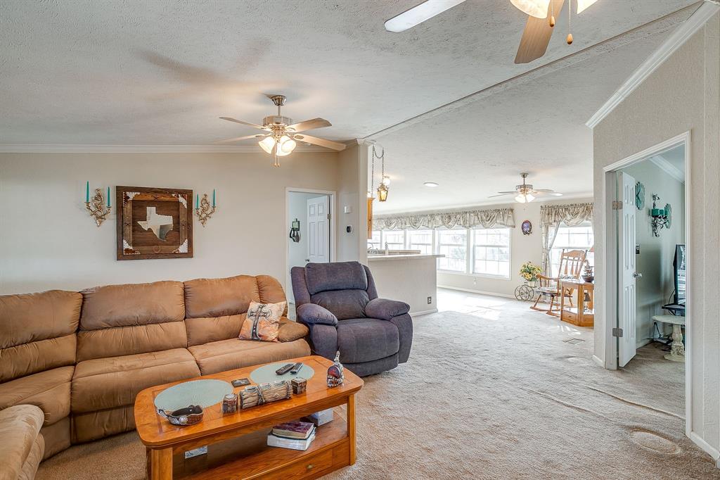 6724 Midway Road Springtown, TX 76082 - Photo 8 of 39 a living room with furniture a ceiling fan and a window