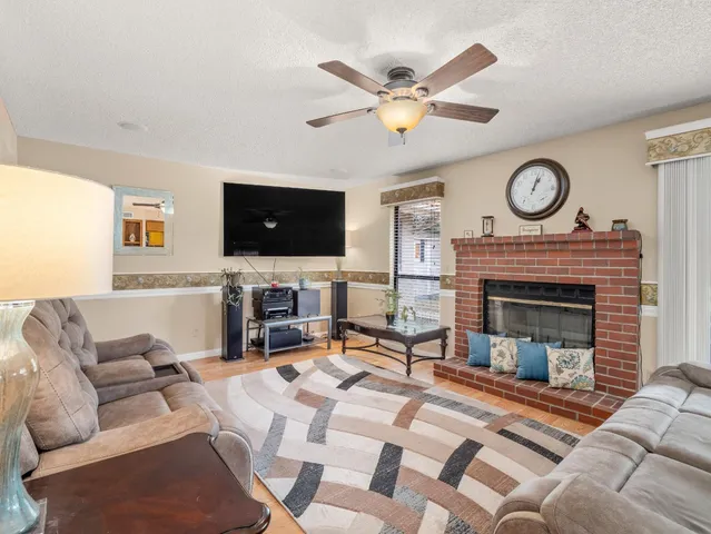 a living room with furniture a fireplace and a flat screen tv