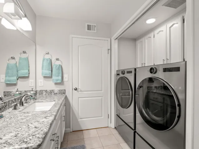 a view of a kitchen with sink washer and dryer