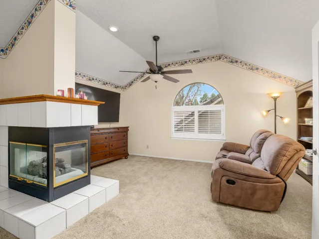 a living room with furniture a fireplace and a chandelier