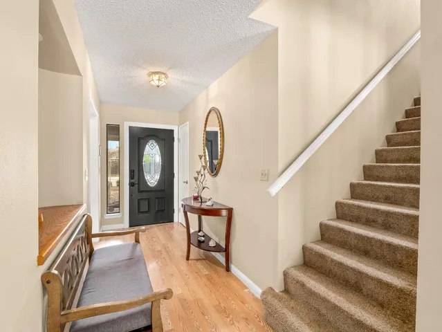 a view of staircase with furniture and a mirror