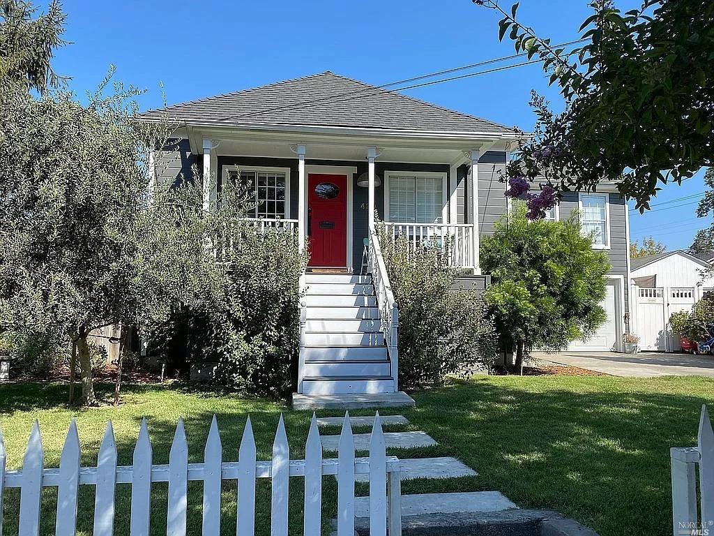 a front view of a house with a garden