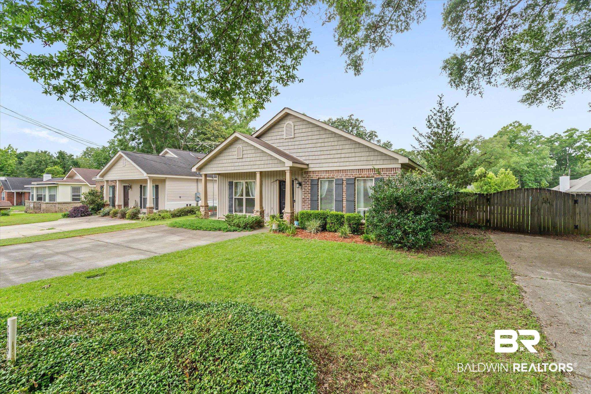 800 Galoway Avenue Mobile, AL 36609 - Photo 20 of 22 Single-story residence featuring a partial brick facade, shingle siding, and a covered front porch