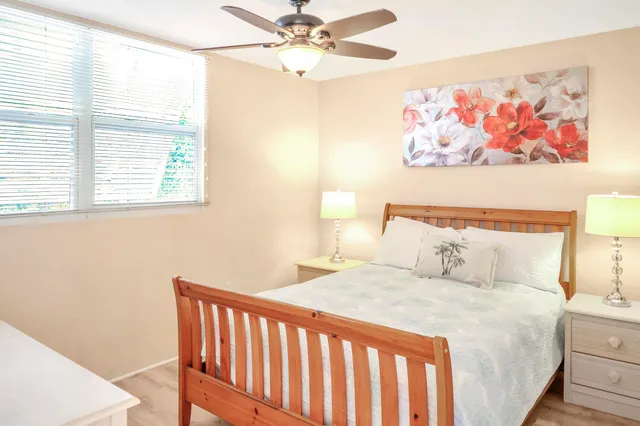 a bedroom with a bed and a painting on the wall