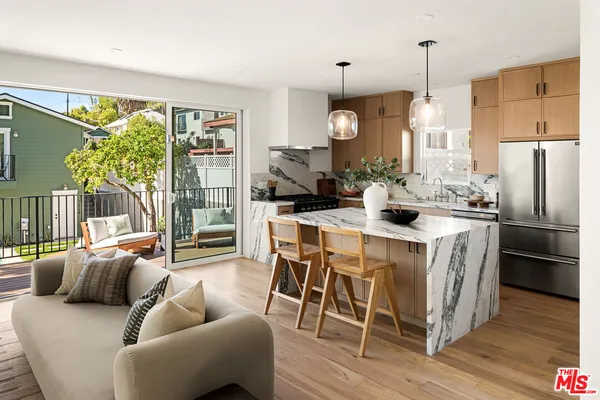 a kitchen with granite countertop a sink a stove and cabinets