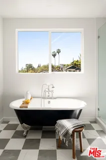 a utility room with cabinets washer and dryer