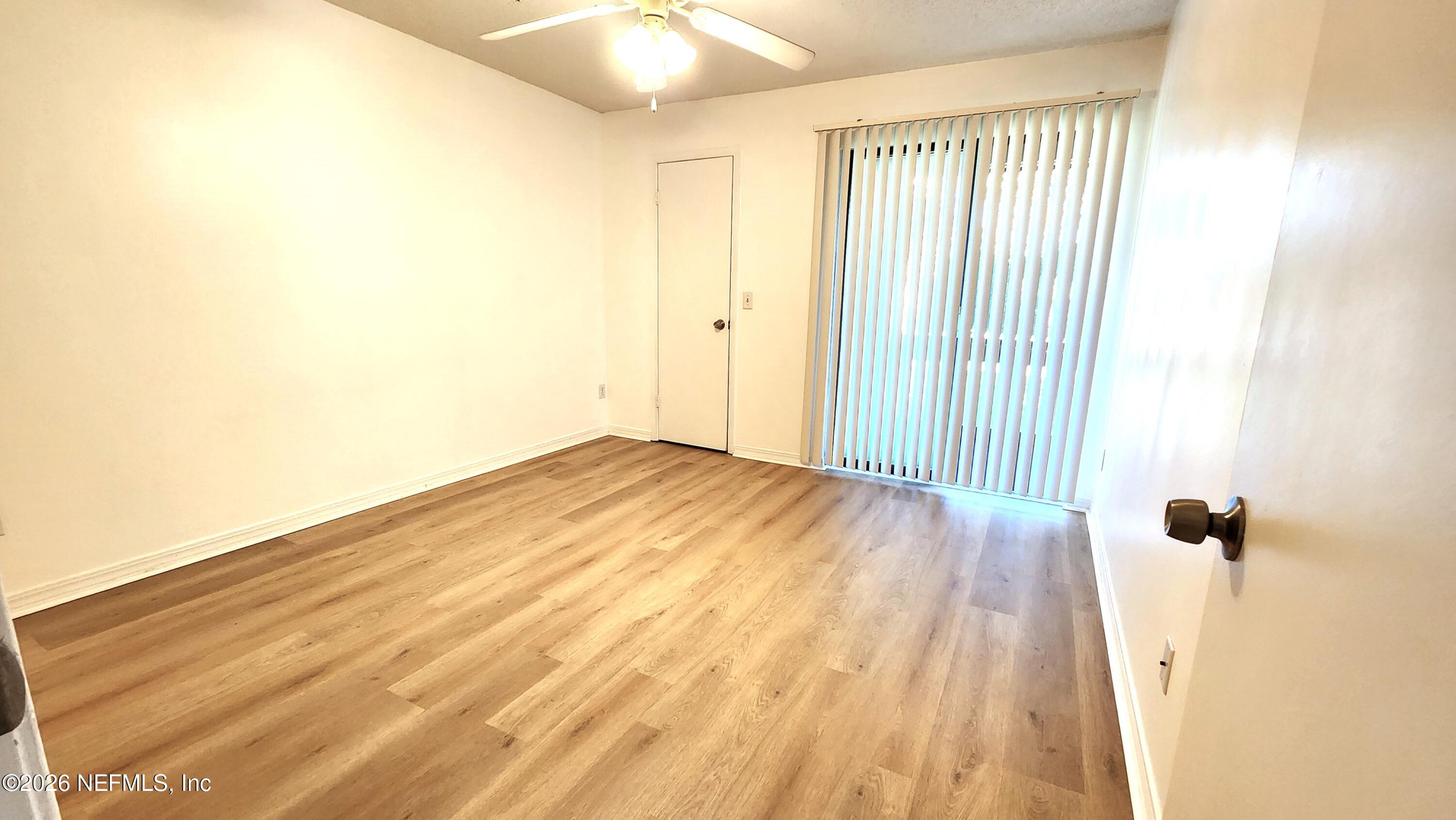 10200 Belle Rive Boulevard, Unit 96 Jacksonville, FL 32256 - Photo 11 of 19 a view of a room with wooden floor and bathroom