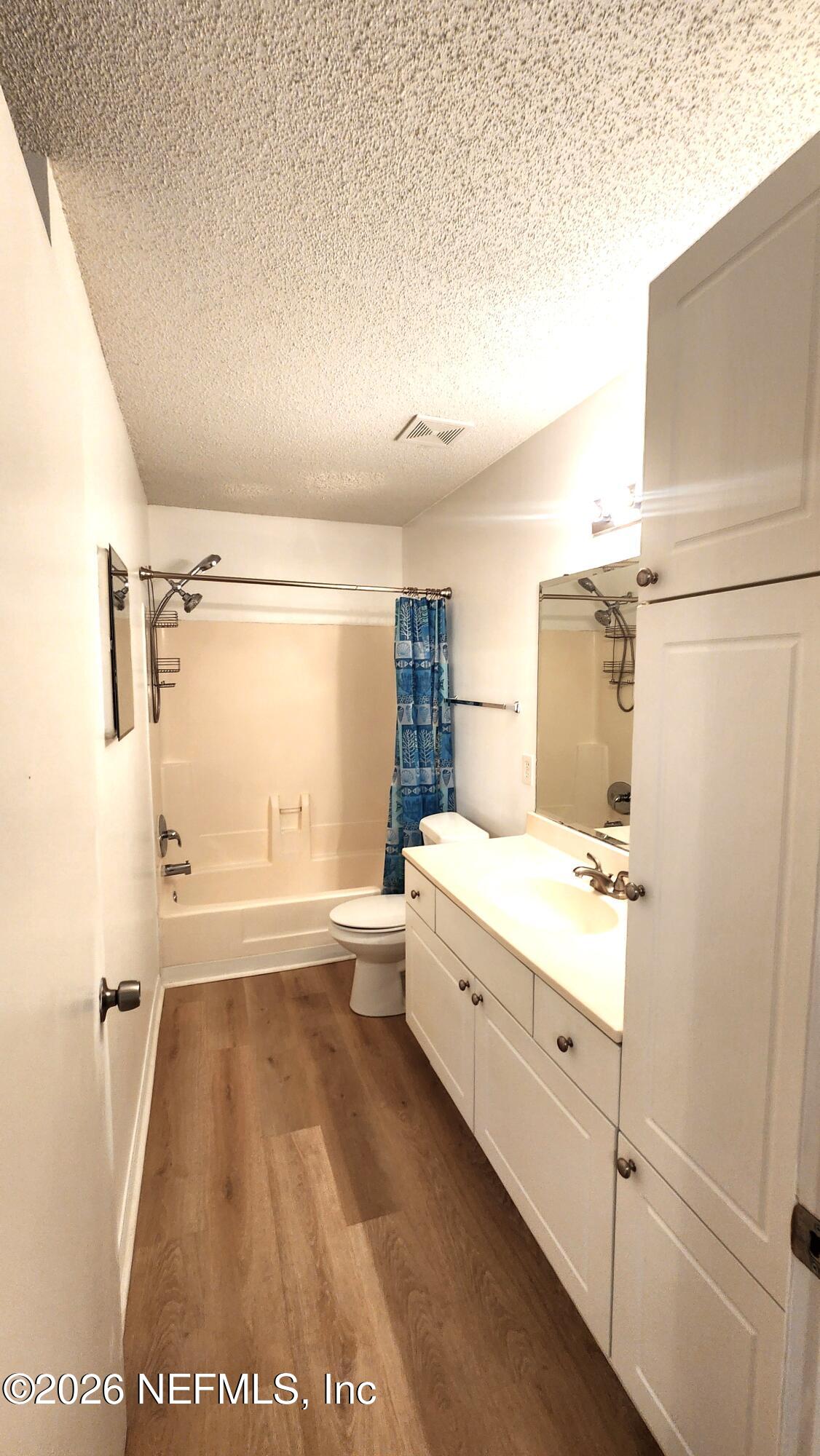 10200 Belle Rive Boulevard, Unit 96 Jacksonville, FL 32256 - Photo 12 of 19 a bathroom with a tub sink and a shower