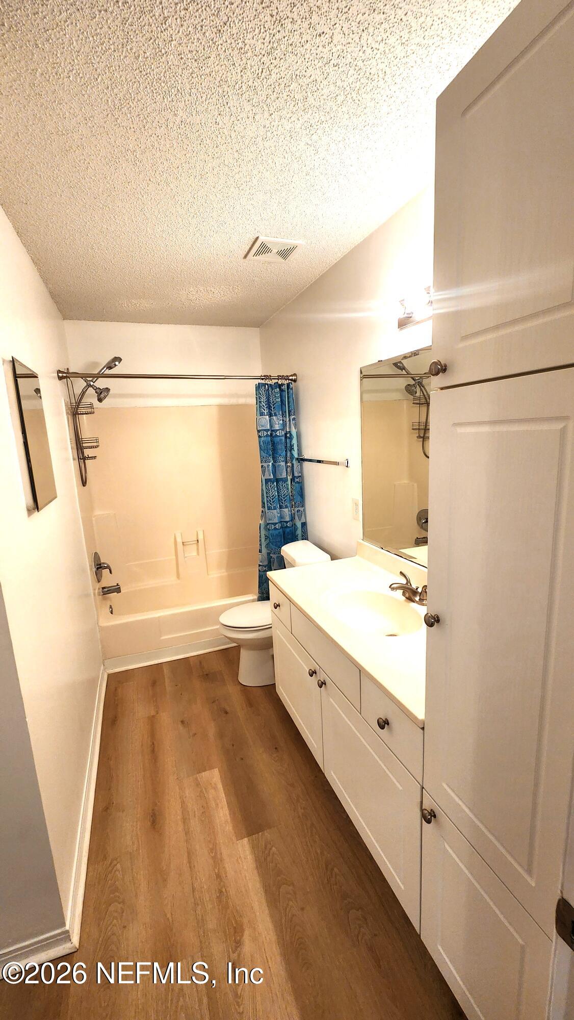 10200 Belle Rive Boulevard, Unit 96 Jacksonville, FL 32256 - Photo 13 of 19 a bathroom with a tub a sink and a view of living room