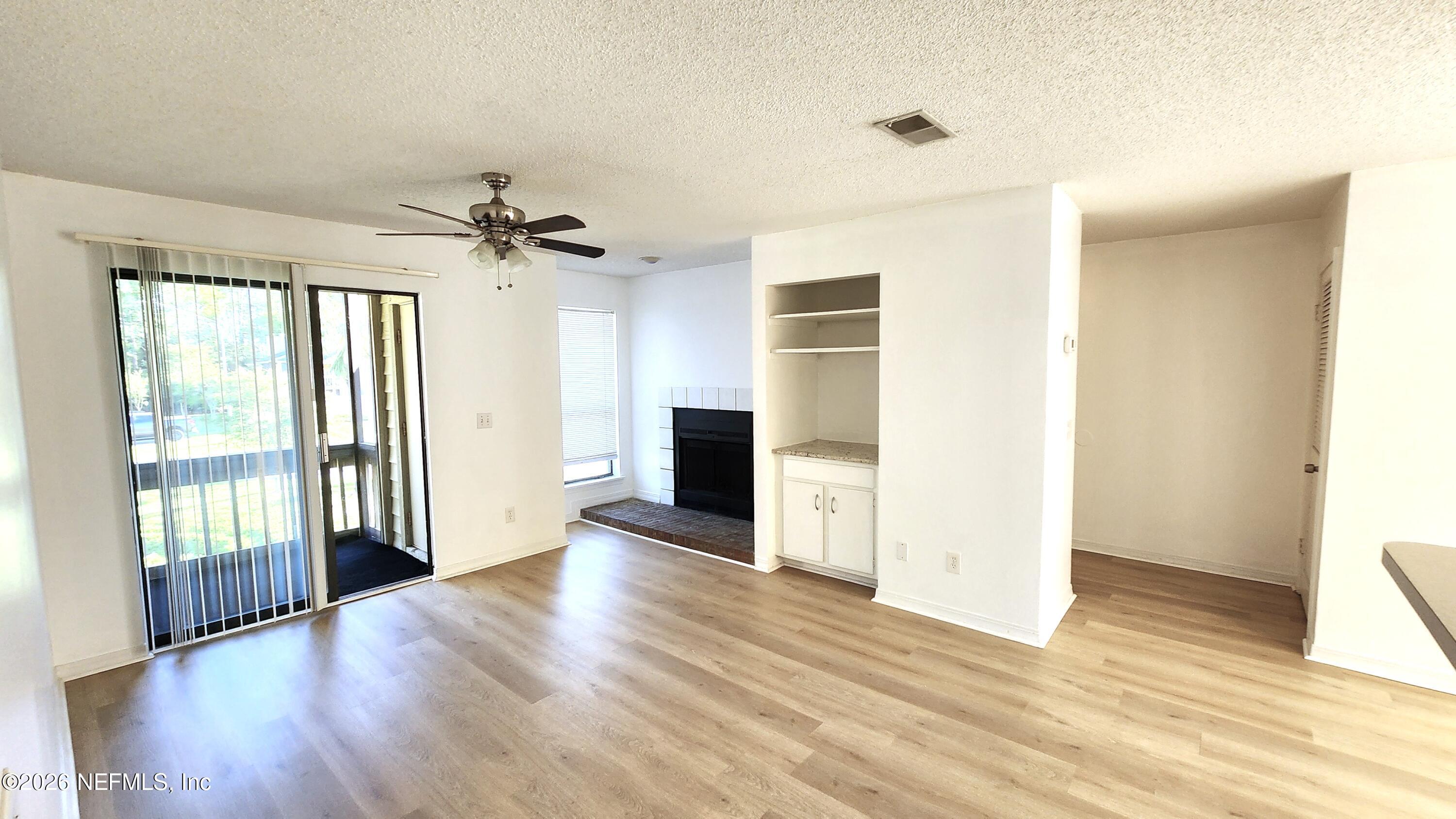 10200 Belle Rive Boulevard, Unit 96 Jacksonville, FL 32256 - Photo 14 of 19 a view of a livingroom with wooden floor and a ceiling fan