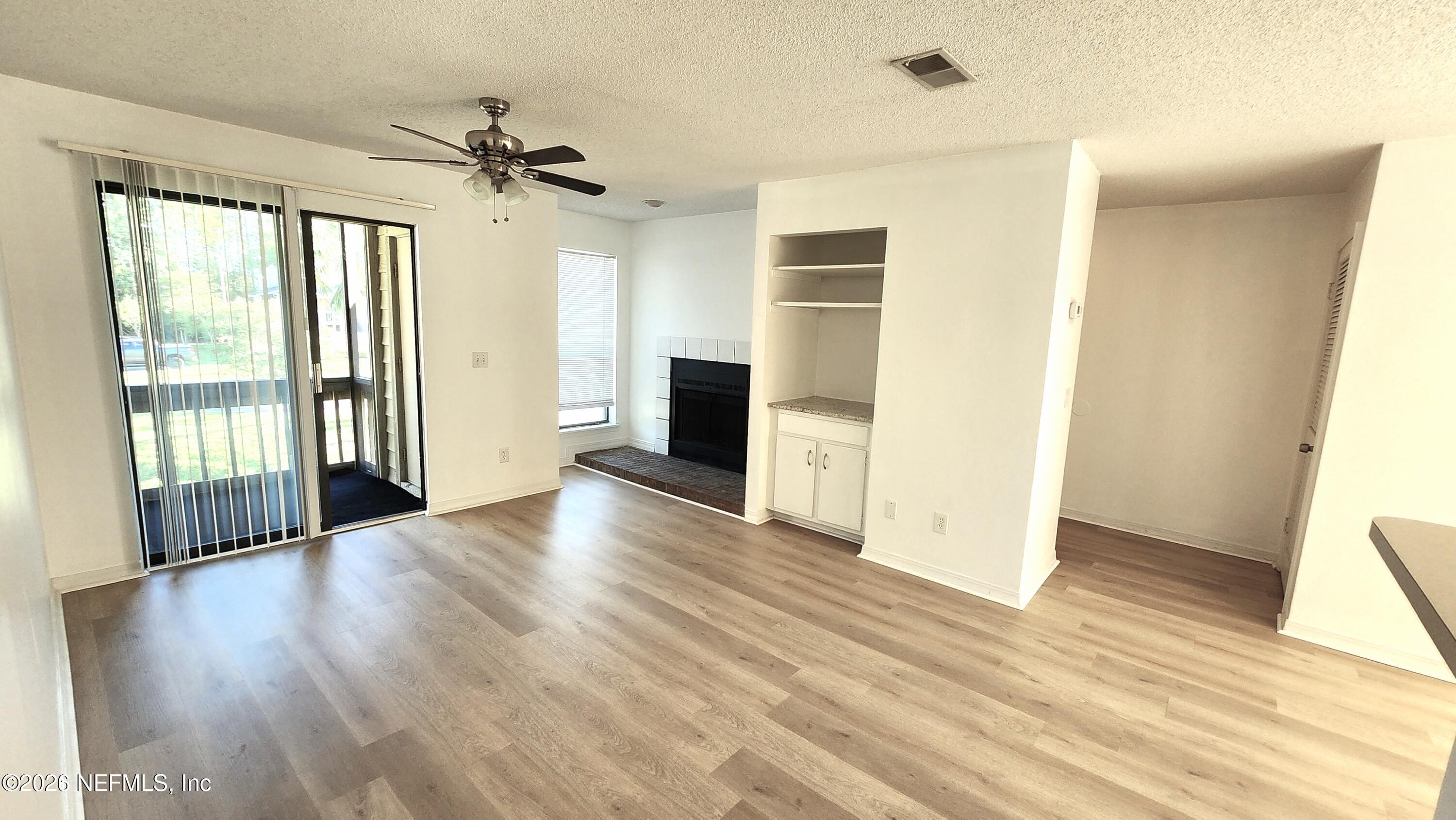 10200 Belle Rive Boulevard, Unit 96 Jacksonville, FL 32256 - Photo 3 of 19 a view of a livingroom with wooden floor and a ceiling fan