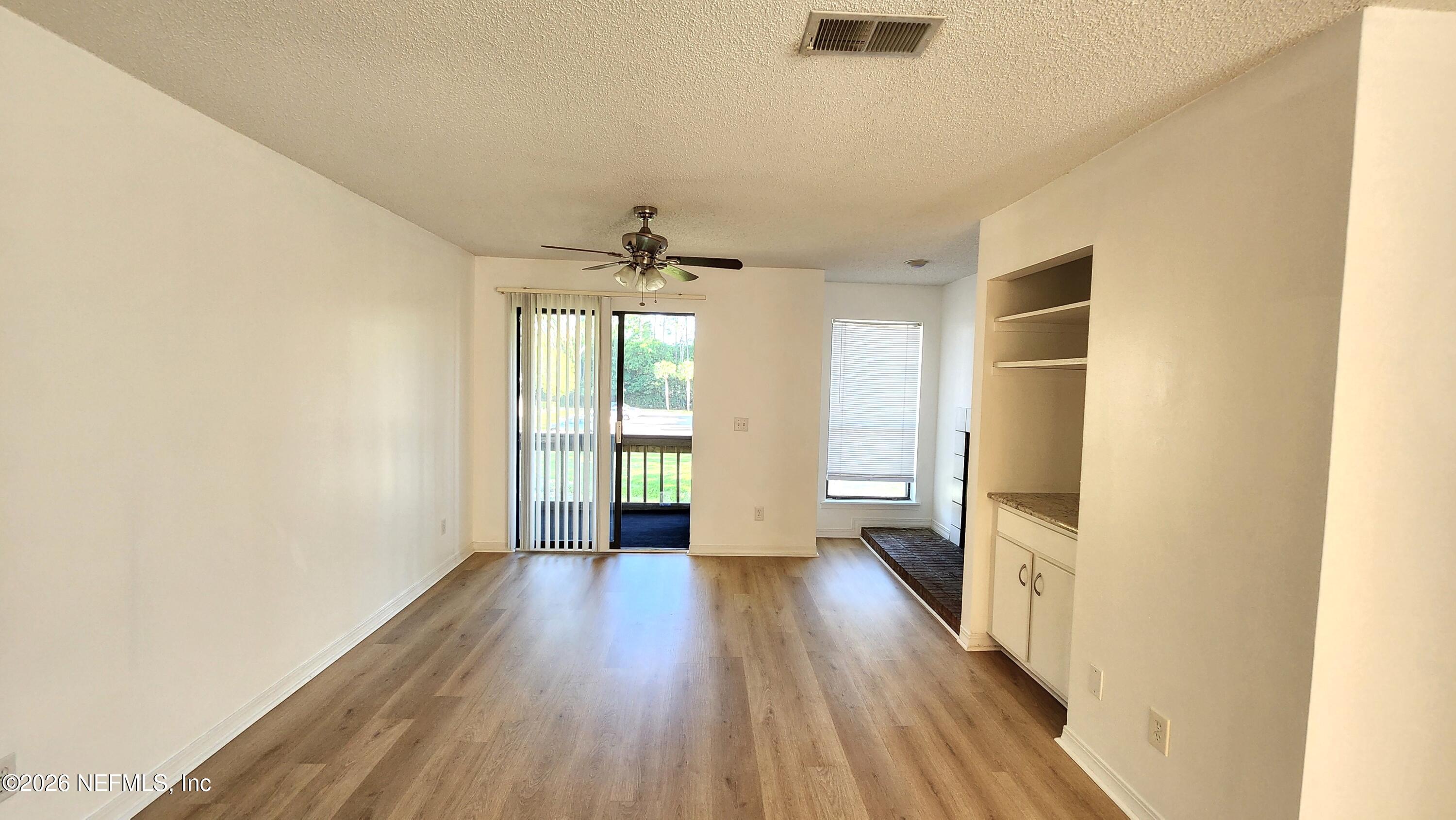 10200 Belle Rive Boulevard, Unit 96 Jacksonville, FL 32256 - Photo 4 of 19 a view of hallway with wooden floor and chandelier