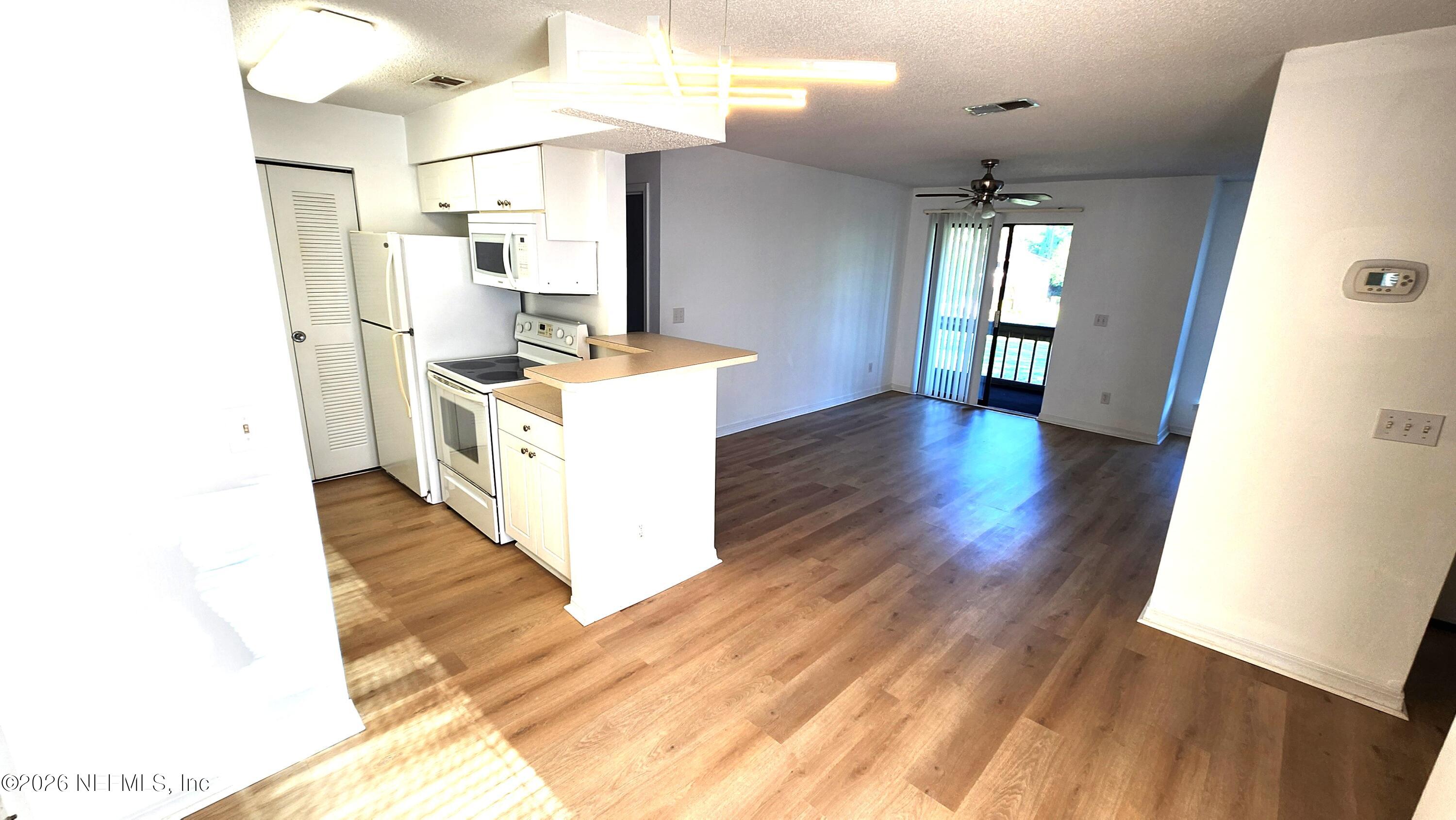 10200 Belle Rive Boulevard, Unit 96 Jacksonville, FL 32256 - Photo 5 of 19 a kitchen with a sink and wooden floor