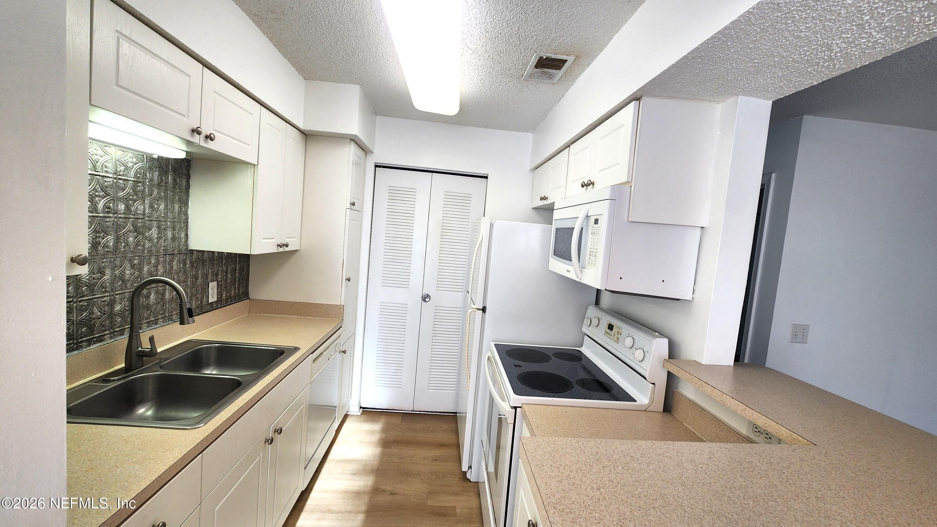 10200 Belle Rive Boulevard, Unit 96 Jacksonville, FL 32256 - Photo 7 of 19 a kitchen that has a sink a refrigerator and a sink