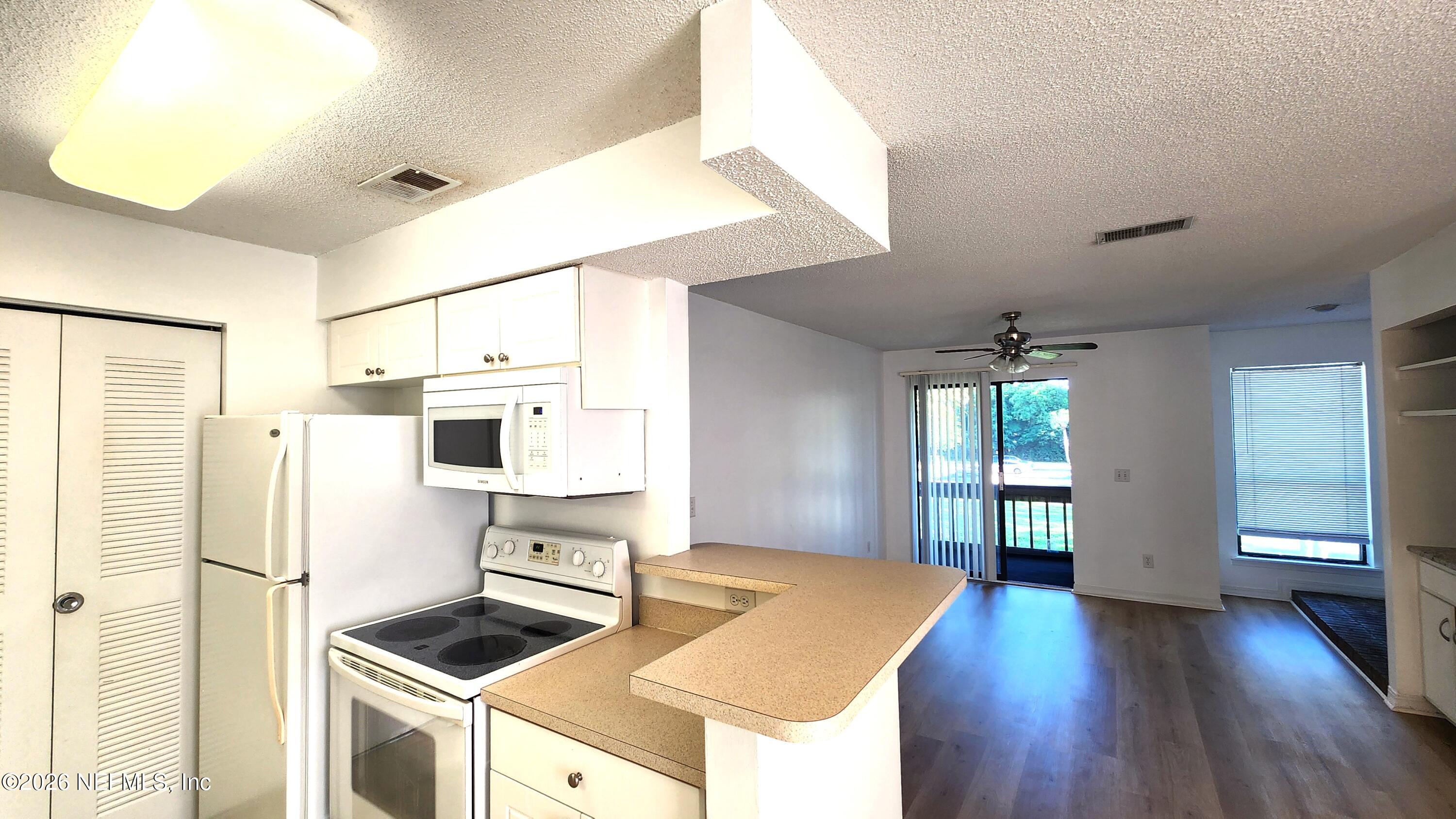 10200 Belle Rive Boulevard, Unit 96 Jacksonville, FL 32256 - Photo 8 of 19 a kitchen with stainless steel appliances a refrigerator and a stove top oven