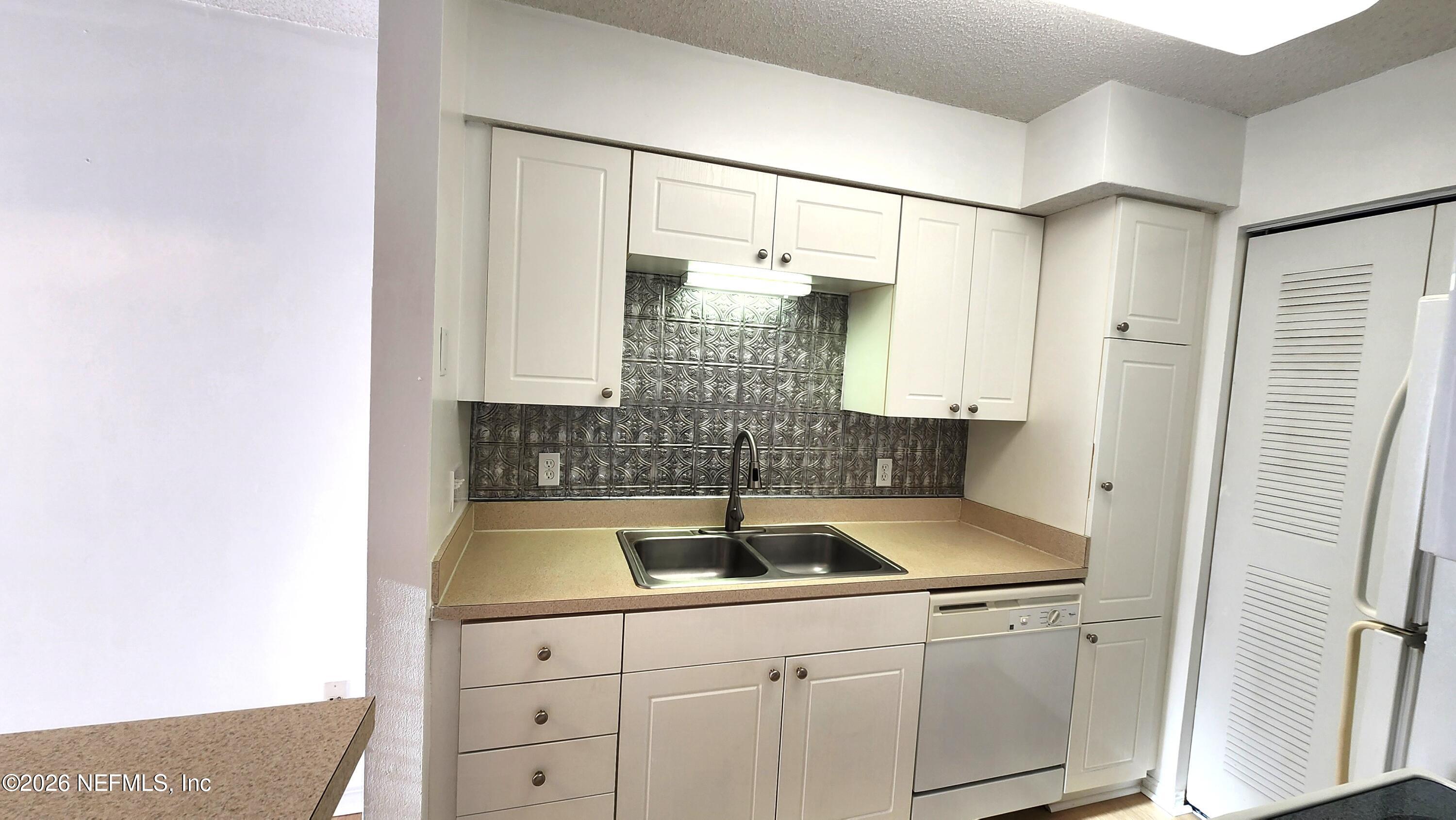 10200 Belle Rive Boulevard, Unit 96 Jacksonville, FL 32256 - Photo 9 of 19 a kitchen with a sink and cabinets