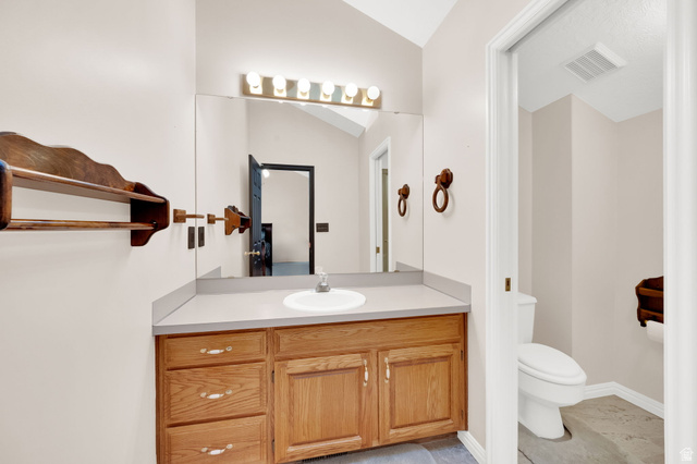 5057 South Ridgedale Drive Ogden, UT 84403 - Photo 33 of 69 Bathroom vanity with a light wood-finish cabinet, countertop, and an integrated sink