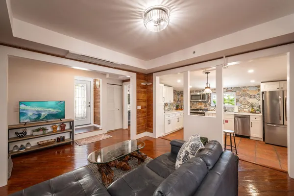 a living room with furniture and a flat screen tv