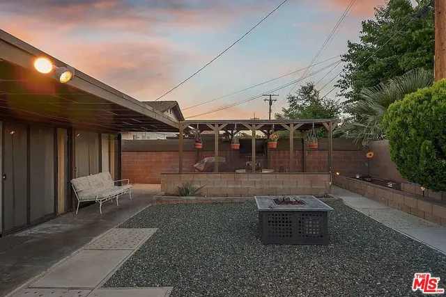 a backyard of a house with outdoor seating