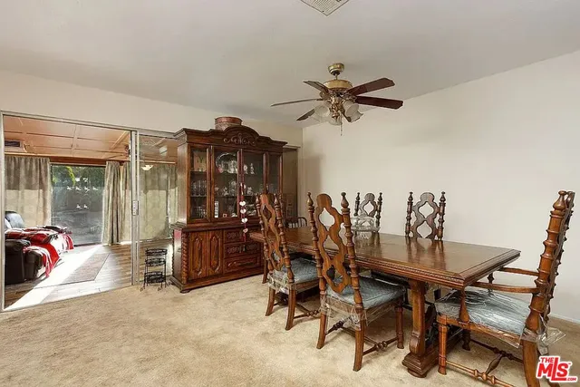 a view of a dining room with furniture and window